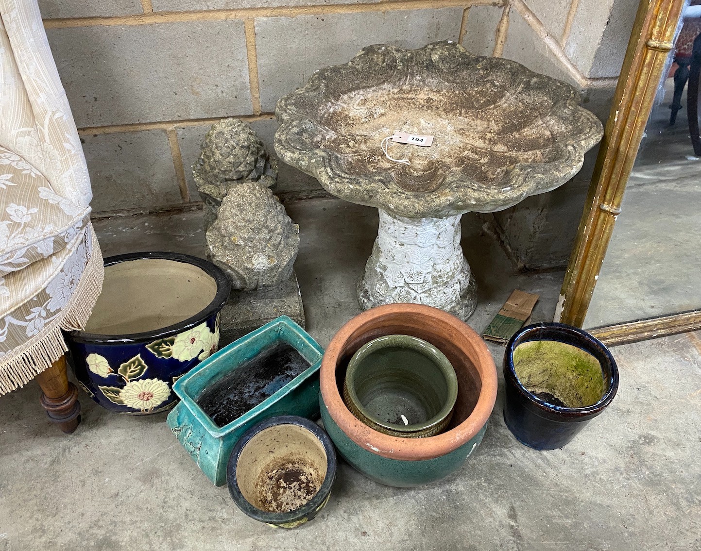 A reconstituted stone scallop shell bird bath, height 46cm, a pair of pineapple finials and six planters